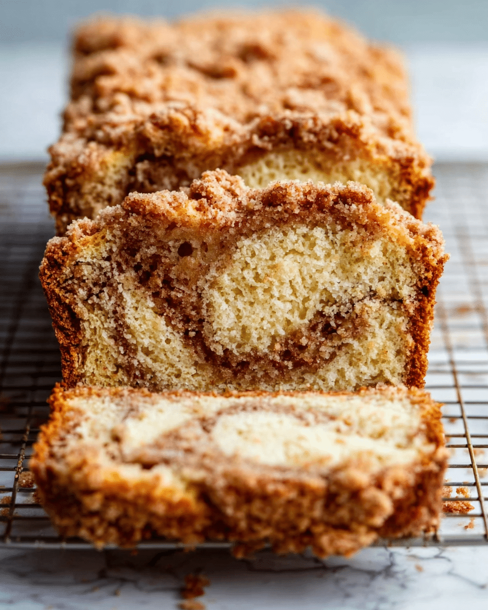 A square baking pan is filled with a smooth, pale yellow batter spread evenly inside. One side of the batter is being sprinkled with a layer of fine, brown cinnamon sugar, creating a textured contrast as it covers about half of the surface. A woman's hand is delicately sifting the cinnamon sugar from above while the other woman's hand steadies the pan on a wooden surface. In the background, there is a soft-focus checkered cloth. photo taken with an iphone --ar 4:5 --v 7