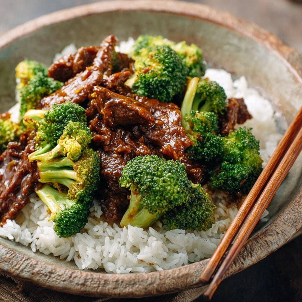 The image shows a white bowl filled with a creamy pasta dish. At the bottom layer, there are round, smooth tortellini in a light cream sauce. On top and mixed with the pasta, there are bright green broccoli pieces adding a fresh look. Scattered above are golden-brown grilled chicken pieces with a slightly crispy texture. The dish is topped with a sprinkle of finely grated cheese and black pepper, giving it a speckled appearance. The background is a white marbled surface. Photo taken with an iphone --ar 4:5 --v 7