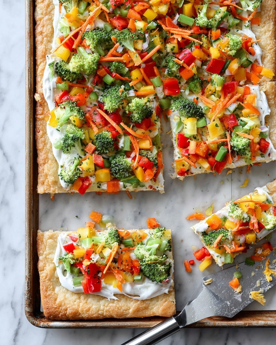 The image shows a rectangular flatbread divided into square and rectangular pieces on a silver tray with a white marbled surface beneath. The flatbread has three layers; the bottom layer is a golden-brown baked crust, the middle layer is a smooth white spread, likely cream cheese, and the top layer consists of colorful chopped vegetables including bright green broccoli florets, thin orange carrot strips, small yellow and red bell pepper chunks, and green cucumber pieces, evenly scattered. There is a metal knife with a black handle placed on the tray, partially under one of the cut pieces. Photo taken with an iphone --ar 4:5 --v 7